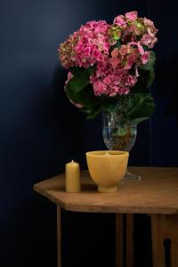 a vase of pink flowers and a candle on a table at The Homestead at Ballandean Lodge in Ballandean +48 photos