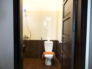 a bathroom with a toilet with a towel on the seat at Jolie Villa Hoi An in Hoi An