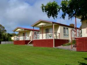 uma casa com um relvado verde em frente em Moss Vale Village Park em Moss Vale