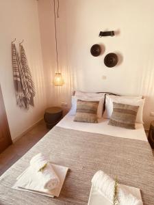 a bedroom with a large bed with white sheets and pillows at Plaka Villa 2 Naxos in Plaka