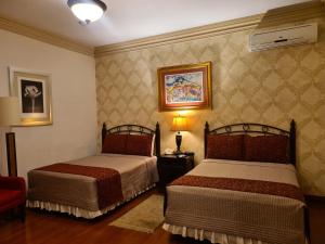 Giường trong phòng chung tại Hotel Casa Divina Oaxaca