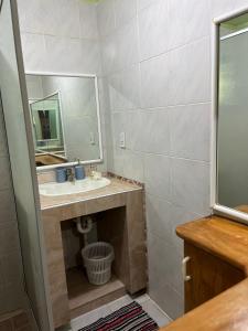 a bathroom with a sink and a mirror at Sharnytas Guesthouse AIR CONDITIONED in Avarua +7 photos