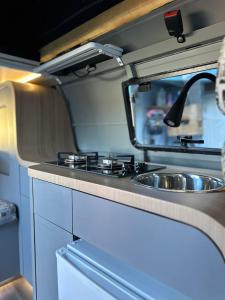 a kitchen with a sink in an rv at Hawaii Surf Campers in Wahiawa