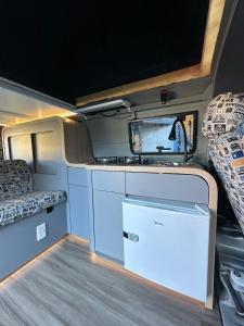 an interior view of an rv with a kitchen and a refrigerator at Hawaii Surf Campers in Wahiawa
