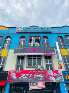 a building with signs on the front of it at SYAHIRAH HOTEL in Marang