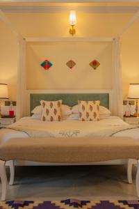 a bedroom with a large bed with kites on the wall at Laalee in Jaipur