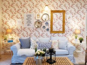 a living room with a blue couch and floral wallpaper at Prima Villa Apartment Tanah Rata Cameron Highland in Tanah Rata