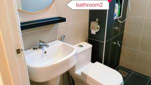 a bathroom with a white toilet and a sink at Kulai D'Putra Suites 1min to ioiMall near JPO, Senai Airport in Kulai