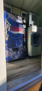 a view of a pepsi machine in a room at Plaza Motel in Joplin
