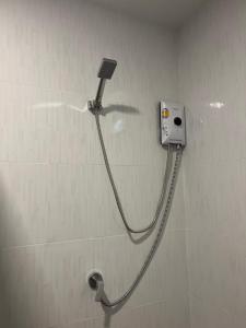 a shower with a hose attached to a wall at Dusit Long Beach in Ko Lanta