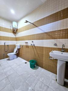 a bathroom with a sink and a toilet at Gopal Hotel and Palace in Jhunjhunūn