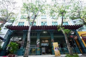 ein Gebäude mit Bäumen davor in der Unterkunft Bonita Boutique Hotel in Ho-Chi-Minh-Stadt