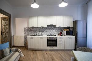a kitchen with white cabinets and a refrigerator at Civico 10 in Sanremo