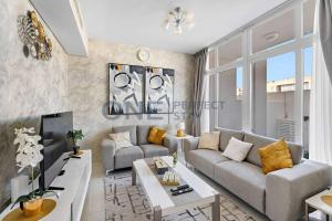 a living room with a couch and a table at Spacious 3BR Townhouse in Mimosa, Damac Hills 2 in Dubai