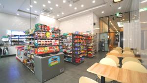 a grocery store with tables and chairs in a store at Golden Tulip Essential Namgang in Jinju