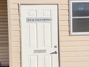 a white door with a sign that reads ice and cold drinks at Plaza Motel in Joplin