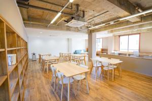 a room with tables and chairs in a building at IKI Island HUB in Iki