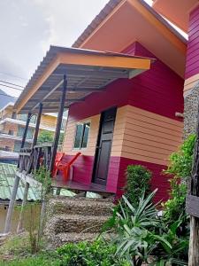 a colorful house with a red door at Cliff View Bungalows in Ko Chang