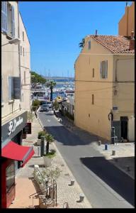 a view of a street with buildings and a street at COTE PORT T2 vue port centre ville Bandol in Bandol