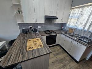 a kitchen with a wooden counter top and a sink at Secure Private Flatlet in Newton Park in Port Elizabeth