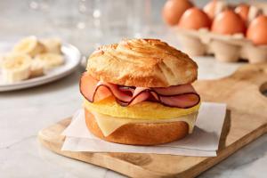 a sandwich with meat and cheese on a bun on a cutting board at SpringHill Suites by Marriott Scranton Montage Mountain in Moosic