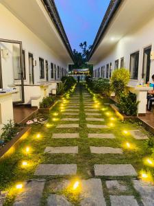 a pathway with lights in the middle of a building at ARECA MUINE HOMESTAY in Phan Thiet