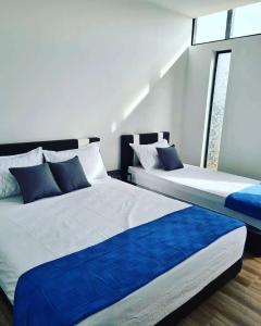 two beds sitting next to each other in a room at Laman Gadang in Johol +7 photos