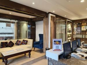 a living room with a couch and a blue chair at Hotel Sri Balaji in Varanasi