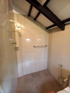 a bathroom with a shower stall and a toilet at Ralapela Eco Resort in Tangalle