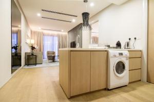 a kitchen with a washer and dryer in a room at 188 suites By Seng Home in Kuala Lumpur