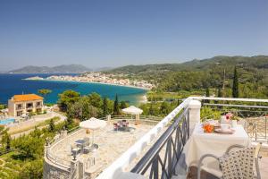 a balcony with a view of a beach and water at PENNY LUXURY APARTMENTS in Kokkari