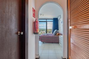 a hallway with a room with a table and a view at Estudio Mirada 309 in Es Pujols
