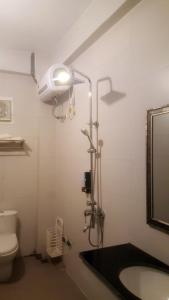 a bathroom with a shower and a sink and a toilet at Sapa Hostel - 679 Đường Điện Biên Phủ, TT. Sa Pa -by BayLuxury in Sa Pa