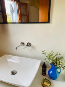 a white sink with a mirror and a blue vase at Plaka Villa 2 Naxos in Plaka +31 photos