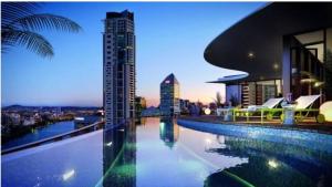 a swimming pool with a view of a building at Great location and amazing views in Brisbane