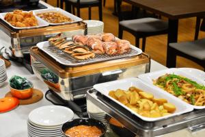 a buffet with different types of food on a table at FLEXSTAY INN Hakodate Station in Hakodate