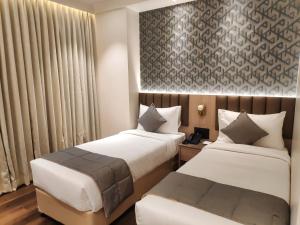 Letto o letti in una camera di Maxxvalue Hotel MIDC - Andheri