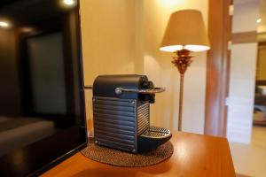 a telephone sitting on a table next to a lamp at Highland Bali Villas, Resort and Spa 
