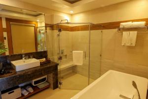 a bathroom with a shower and a tub and a sink at Highland Bali Villas, Resort and Spa 