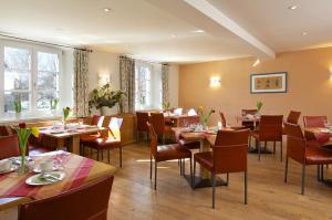 a restaurant with tables and chairs in a room at Braustüble und Hotel zur Post in Weiler-Simmerberg +37 photos