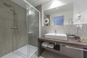 a bathroom with a sink and a shower at Bella Hotel & Restaurant with private dock for mooring boats in San Felice del Benaco