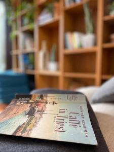 a book sitting on top of a table at Charmantes Altstadthaus mit Dachterrasse in Muggia