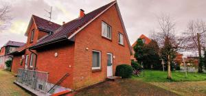 a large red brick house with at Haus-Schwalbennest-Whg-03 in Olsdorf
