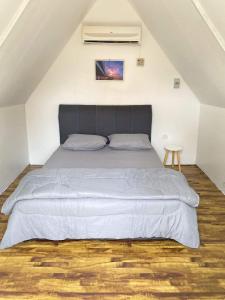 a bedroom with a large bed in a attic at IT SWISS GARDEN in Perai