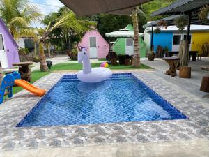 a pool with a plastic inflatable unicorn in the middle at IT SWISS GARDEN in Perai