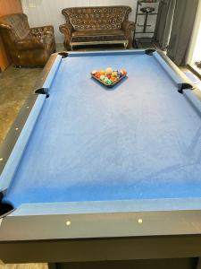 a pool table with a bowl of balls on it at IT SWISS GARDEN in Perai