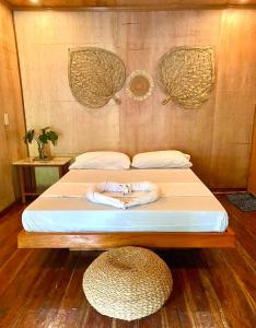 a bed in a room with a hat on it at Bohol Island Homestay in Dauis