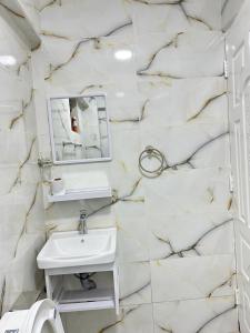 a white bathroom with a sink and a mirror at Regency Stays III in Eldoret