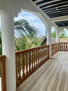 a porch of a house with a view of the ocean at The New Blue Waves Hotel in Jambiani