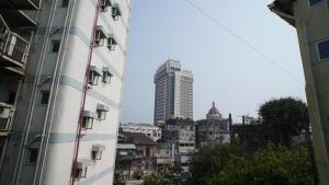 a view of a city from between two buildings at The Colaba Pod in Mumbai